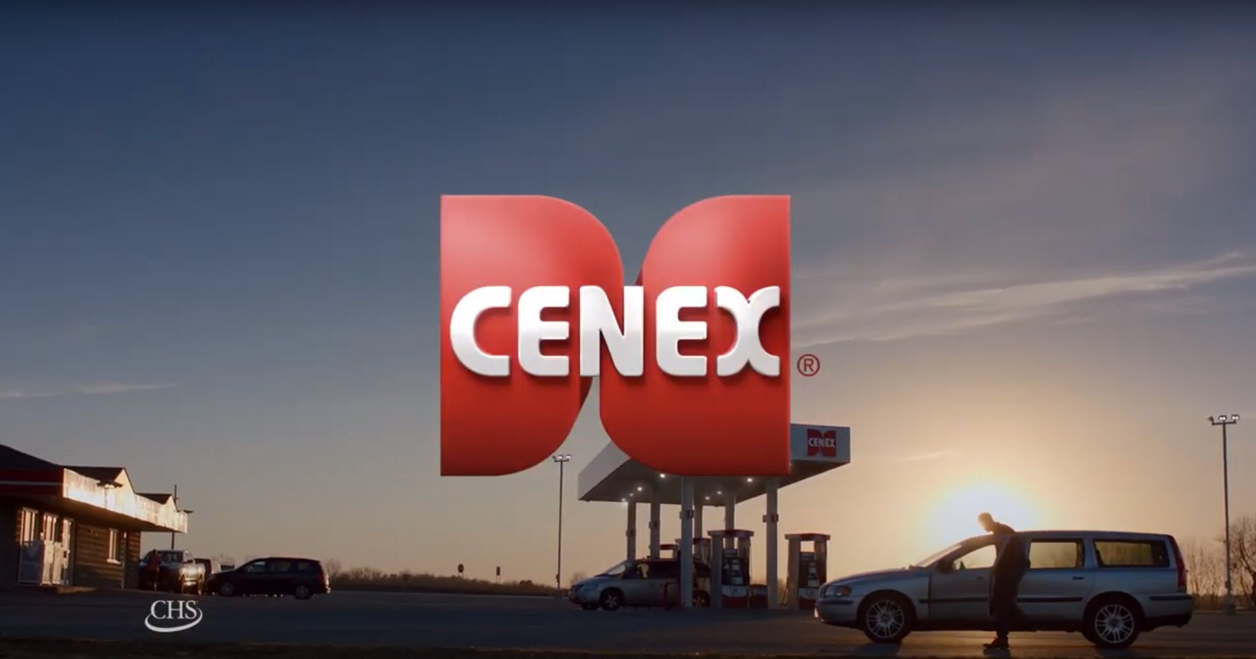 Cenex logo in front of a background of a Cenex gas station at sunset